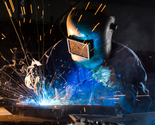 Side view of a welder at work