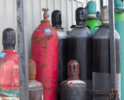 Tanks of gas on side of building